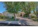 Beautiful home with mature trees and a welcoming front entrance at 7347 E Turquoise Ave, Scottsdale, AZ 85258