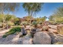 Landscaped courtyard with a tranquil water feature and desert plants at 7445 E Eagle Crest Dr # 1065, Mesa, AZ 85207