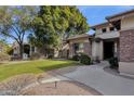 Brick home with lush landscaping and a walkway at 7893 S Stephanie Ln, Tempe, AZ 85284