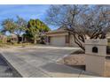 Brick home with a three car garage and a mailbox at 7893 S Stephanie Ln, Tempe, AZ 85284