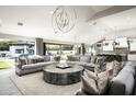 Spacious living room with large windows, comfortable seating, and a stunning chandelier at 9016 N 60Th St, Paradise Valley, AZ 85253