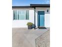 Contemporary teal front door with updated landscaping at 908 E Cavalier Dr, Phoenix, AZ 85014