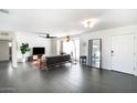 Bright living room with dark gray couch and large TV at 908 E Cavalier Dr, Phoenix, AZ 85014