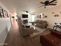 Spacious living room with comfy seating and large TV at 9207 W Highland Ave, Phoenix, AZ 85037