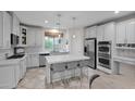 Spacious kitchen with white cabinets, island, and stainless steel appliances at 9236 E Canyon View Rd, Scottsdale, AZ 85255