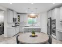 Eat-in kitchen with white cabinets and a large island at 9236 E Canyon View Rd, Scottsdale, AZ 85255