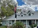 Charming single story home with a gray exterior, white picket fence, and mature landscaping at 1041 E 9Th Dr, Mesa, AZ 85204