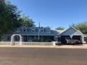 House exterior with a gray exterior, white picket fence, and a spacious yard at 1041 E 9Th Dr, Mesa, AZ 85204