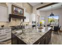 Granite island kitchen with high end appliances and breakfast nook at 10452 E Quartz Rock Rd, Scottsdale, AZ 85255