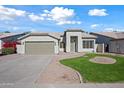 Front view of a house with a garage and attractive landscaping at 1082 W Aspen Ave, Gilbert, AZ 85233