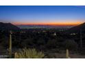 Stunning panoramic view of city lights and mountain landscape at sunset at 10944 E Whistling Wind Way, Scottsdale, AZ 85255