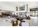 Spacious living room with a grand piano, sectional sofa, and high ceilings at 10944 E Whistling Wind Way, Scottsdale, AZ 85255