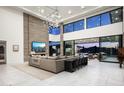 Spacious living room with a fireplace and large windows offering stunning views at 10944 E Whistling Wind Way, Scottsdale, AZ 85255