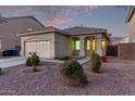 One-story house with a two-car garage and landscaped front yard at 12418 W Pima St, Avondale, AZ 85323