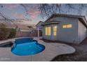 Relaxing kidney-shaped pool with a spa in the backyard at 12418 W Pima St, Avondale, AZ 85323