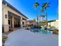 Inviting backyard with a sparkling pool, spa, and covered patio at 12762 W Vista Paseo Dr, Litchfield Park, AZ 85340