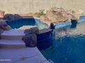 Spacious spa with adjacent pool and rock features at 12762 W Vista Paseo Dr, Litchfield Park, AZ 85340