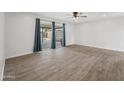 Bright living room with sliding glass doors and wood-look tile at 1312 E Colter St, Phoenix, AZ 85014