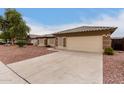 House exterior showcasing a two-car garage and well-maintained yard at 13292 W Statler St, Surprise, AZ 85374