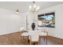 Bright dining room with glass table and four white chairs at 14402 N 45Th St, Phoenix, AZ 85032