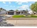 Single story home with artificial turf front yard at 14402 N 45Th St, Phoenix, AZ 85032