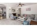 Spacious living room with a fireplace and large windows at 14518 W Port Royale Ln, Surprise, AZ 85379