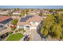 Two-story house with solar panels, landscaped yard, and driveway at 1684 E Coconino Dr, Chandler, AZ 85249