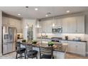 Modern kitchen with stainless steel appliances and an island at 19417 W Badgett Ln, Litchfield Park, AZ 85340