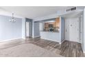 Bright living room featuring modern floors, light blue walls, and an open layout to the kitchen at 200 E Southern Ave # 118, Tempe, AZ 85282