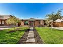 Charming brick home with a walkway leading to the entrance at 2218 N 8Th St, Phoenix, AZ 85006