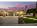 Stunning curb appeal with a three-car garage and lush landscaping at 22331 N 80Th Ave, Peoria, AZ 85383