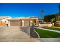 Three-car garage, attractive landscaping, and a welcoming front porch at 22331 N 80Th Ave, Peoria, AZ 85383