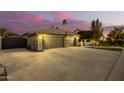 Spacious driveway, three-car garage, and elegant gated entryway at 22331 N 80Th Ave, Peoria, AZ 85383