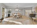 Bright dining room with a round table, wood floors, and access to a patio at 23575 N 75Th Pl, Scottsdale, AZ 85255