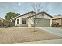 Charming one-story home with a two-car garage and desert landscaping at 33868 N Mercedes Dr, San Tan Valley, AZ 85144