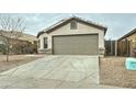 Front view of a single story home with a two-car garage and small front yard at 33868 N Mercedes Dr, San Tan Valley, AZ 85144