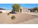 Single-story home with a landscaped front yard and attached garage at 36148 W Seville Dr, Maricopa, AZ 85138