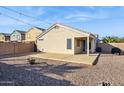 Large backyard with covered patio, fire pit, and gravel landscaping at 36509 W Nina St, Maricopa, AZ 85138