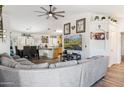 Open concept living room, kitchen, and dining area with large sectional sofa at 36509 W Nina St, Maricopa, AZ 85138