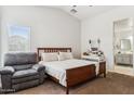 Spacious primary bedroom with a large bed and an ensuite bathroom at 36509 W Nina St, Maricopa, AZ 85138