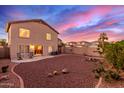 Landscaped backyard with a patio and a view of the sunset at 403 S 228Th Ln, Buckeye, AZ 85326