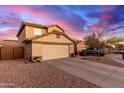 Two-story house with attached garage and a view of the sunset at 403 S 228Th Ln, Buckeye, AZ 85326