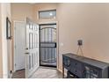 Front entry with security door and dark console table at 4109 E Barwick Dr, Cave Creek, AZ 85331