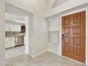 Bright entryway with wood door and view into a modern kitchen at 4149 W Park Ave, Chandler, AZ 85226