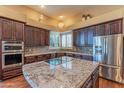 Spacious kitchen with granite countertops and stainless steel appliances at 4410 E Robin Ln, Phoenix, AZ 85050