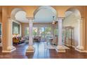 High ceilings and elegant columns grace this open living and dining area at 4410 E Robin Ln, Phoenix, AZ 85050