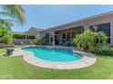 Inviting kidney-shaped pool with spacious surrounding patio at 4410 E Robin Ln, Phoenix, AZ 85050