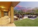 Inviting backyard with a covered patio, outdoor seating, and well-maintained lawn at 4813 S Quantum Way, Mesa, AZ 85212