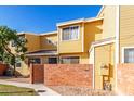 Front view of a yellow two-story townhome with a gated entrance at 510 N Alma School Rd # 158, Mesa, AZ 85201