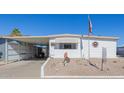 Front view of a white manufactured home with carport and desert landscaping at 5646 E Player Pl, Mesa, AZ 85215